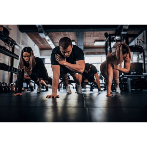 Group of people performing a plank exercise in a gym, with one hand touching the opposite shoulder.